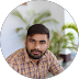 Young Indian man in formal shirt, confident expression, clean light background