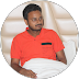 Young Indian man in formal shirt, confident expression, clean light background
